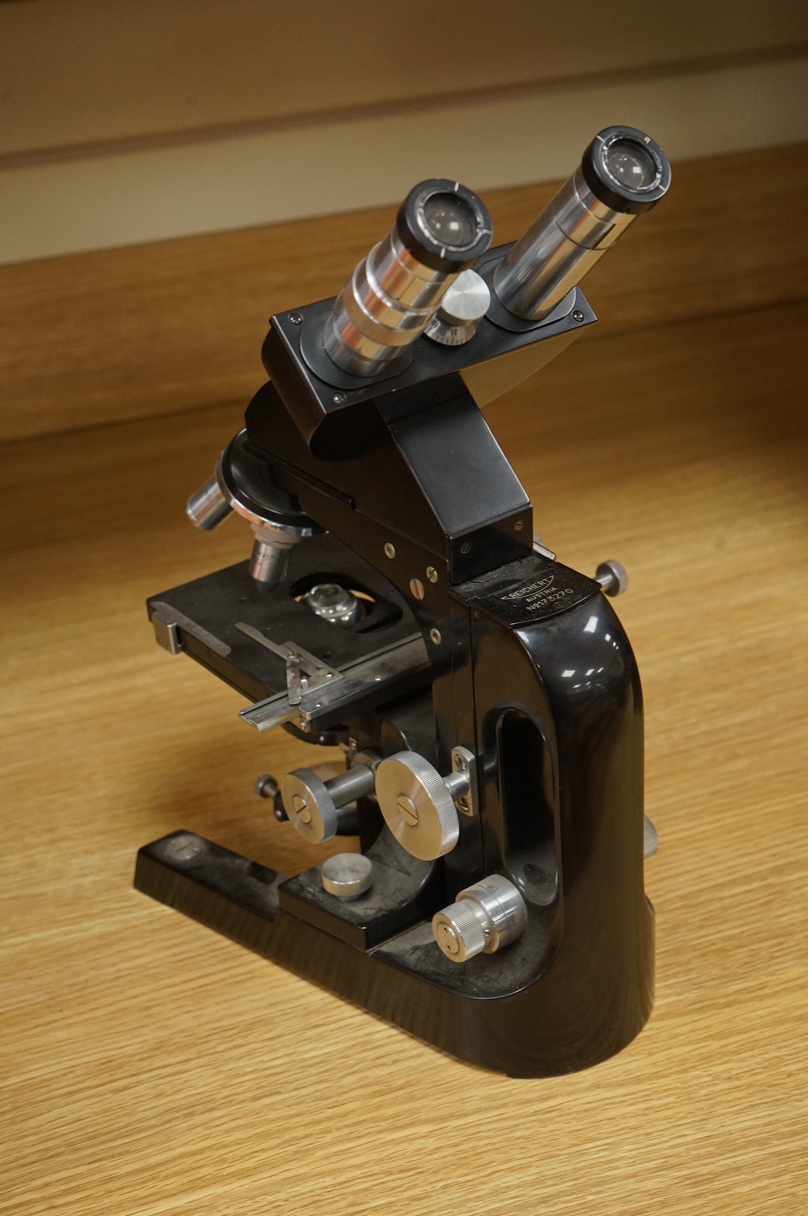 A mid 20th century Reichert, Austria binocular microscope, 34cm high.
